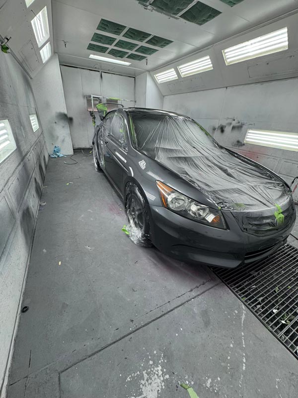 Honda Accord properly masked and prepared for paint in spray booth