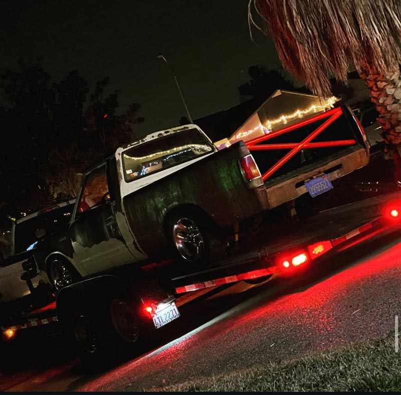 Nissan 720 with V8 swap being transported on trailer at night