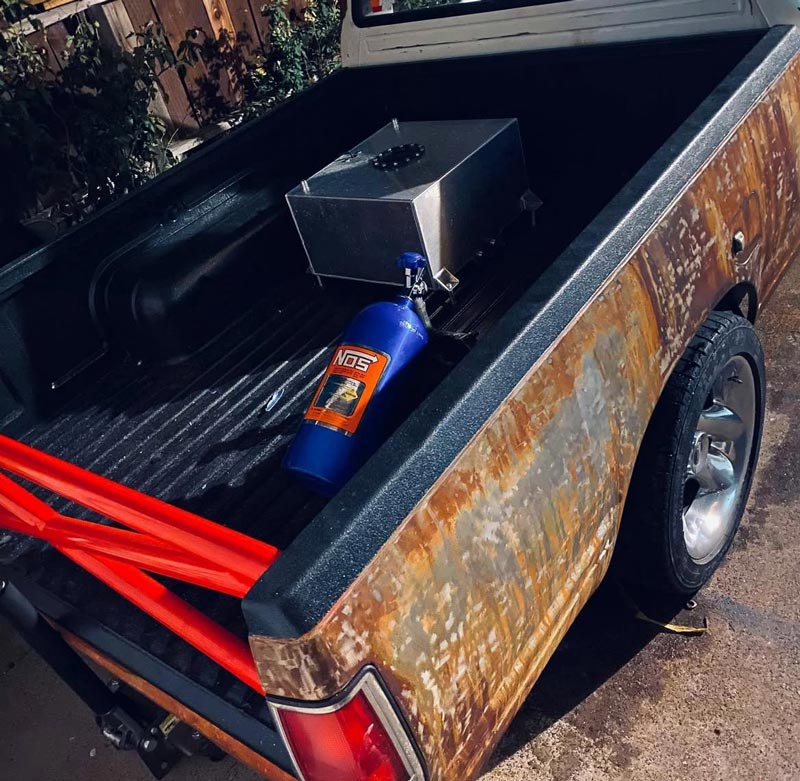 Close-up of NOS nitrous system installation in truck bed