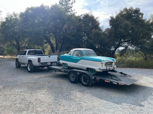 Classic car towing service with vintage turquoise and white vehicle